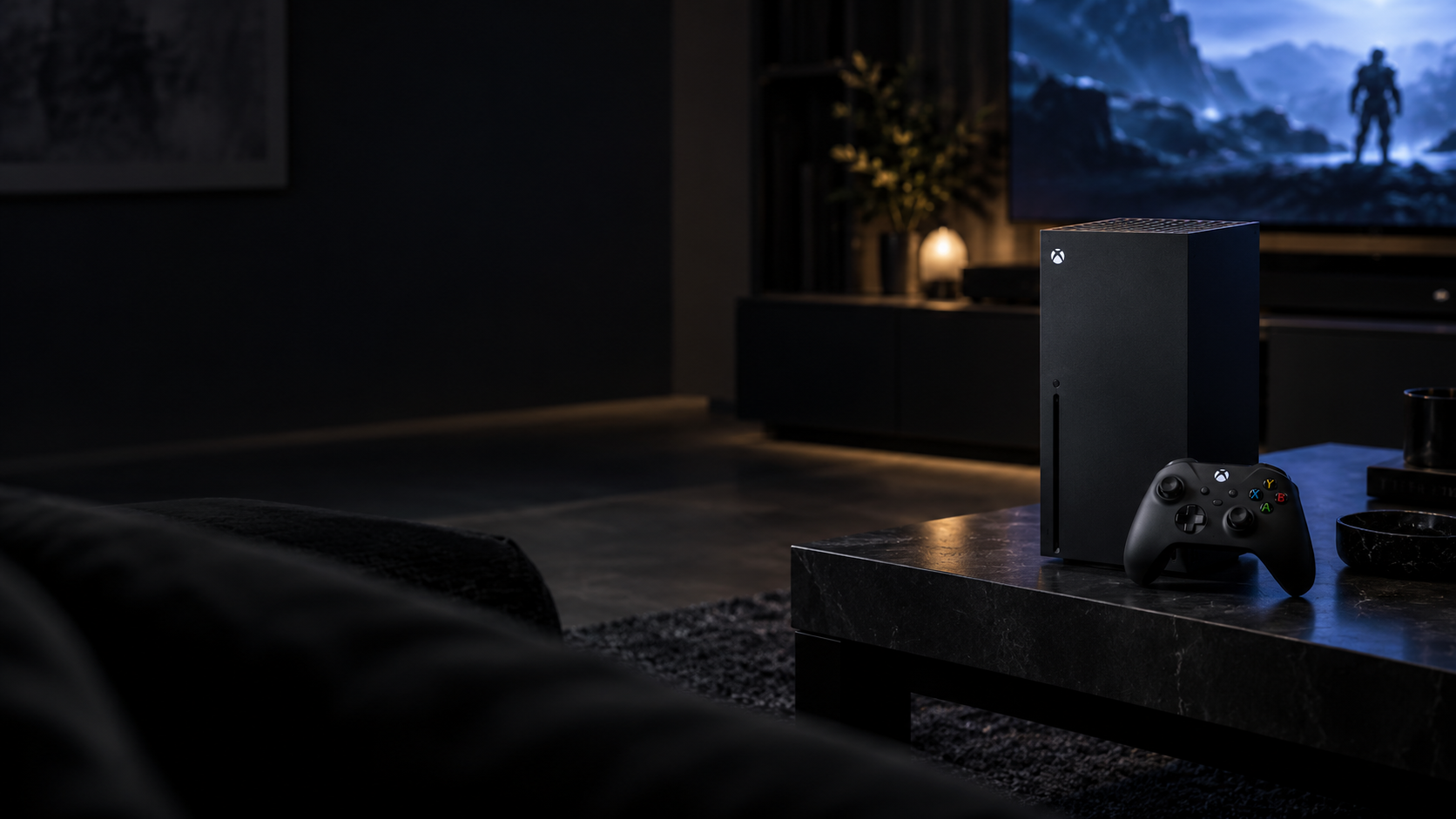 Console and controller beside a television in a dim living room